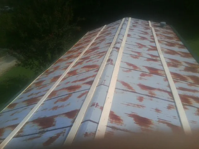 Rusted metal roof panels with new wood purlins before replacement — Storm Damage Roof Repair in Parker Ford by Roofing Brothers